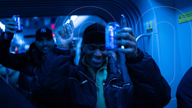 A person enjoying the evening, holding a can of Heineken.