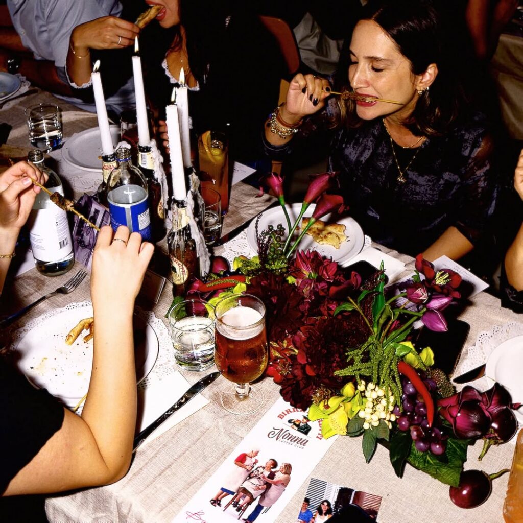 Nonnas and fans gathered around a large table to share a convivial meal at the Super Nonnas Club.